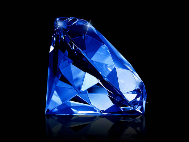 istock Dazzling diamond Blue gemstones on black background 1354539656
