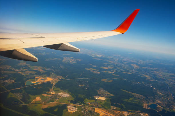 istock Classic image through aircraft window onto wing. Flight view over Russia 1354545524