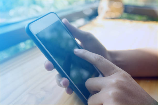 istock Businessman using smartphone in coffee shop 1354549092