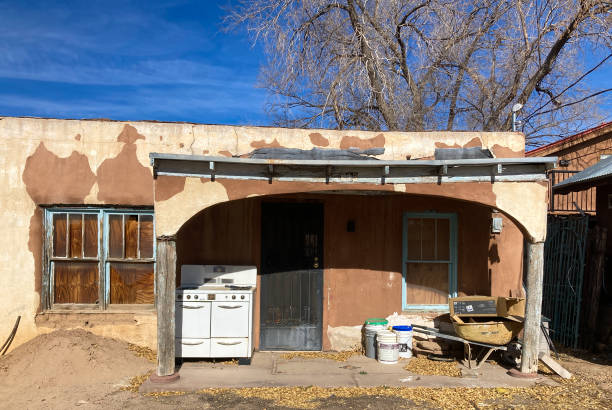 Santa Fe, NM: Traditional Old Adobe House Being Renovated Santa Fe, NM: A traditional old adobe house being renovated; an antique oven stands on the portal (porch). stove oven adobe outdoors stock pictures, royalty-free photos & images