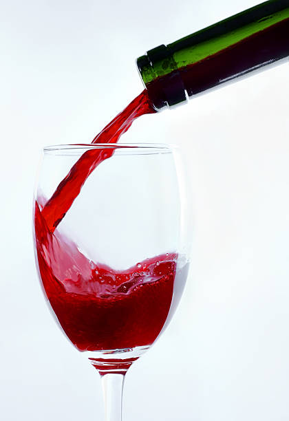 istock Wineglass, bottle, wine is flowing 135455654
