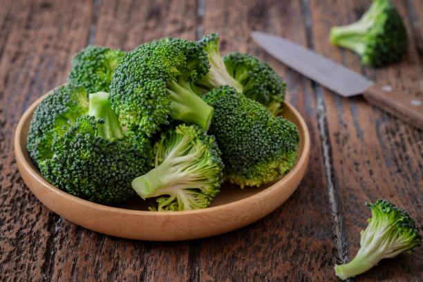 istock Fresh green broccoli on wooden plate 1354557720