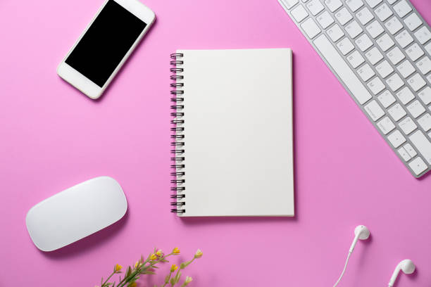 istock close up of workspace desk with smartphone, notebook, laptop or computer keyboard with pink copy space background, minimal style, for creative flat lay concept 1354558433