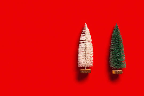 istock Christmas tree green and white colors on red background with copy space. Bright minimal New Year flat lay with plastic festive fir, holiday winter concept 1354559183