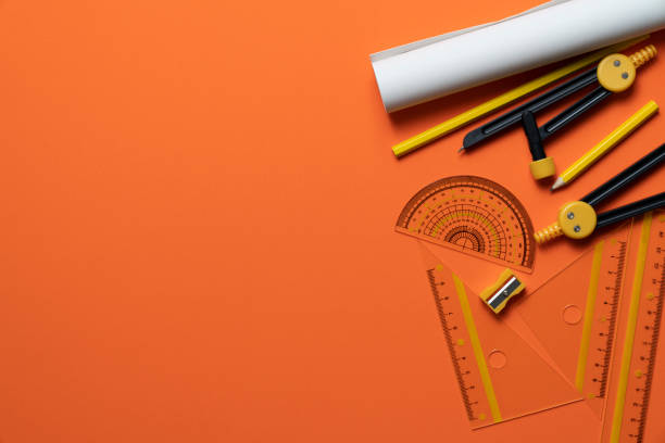 engineer or architect desk with stationery on orange table background in the office, project ideas concept