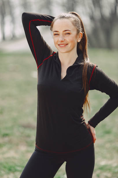 istock Elegant woman in a black uniform in a spring park 1354561177