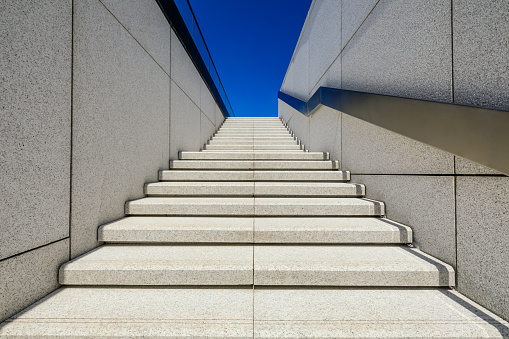 Side view of metal stairs and blue sky.