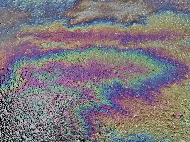 istock Eco concept, oil spill on asphalt road 1354568308