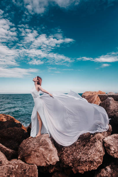 istock Beautiful woman on the rock 1354569384