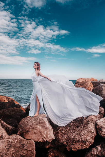 istock Beautiful woman on the rock 1354569386