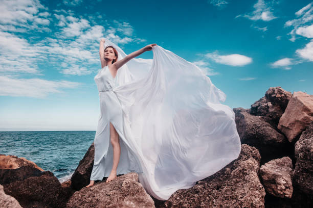 istock Beautiful woman on the rock 1354569394