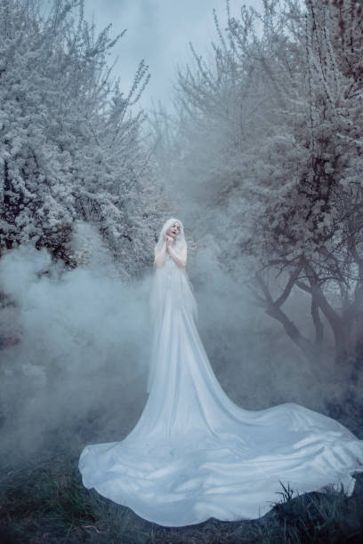 istock Beautiful woman in white cherry blossom 1354569641