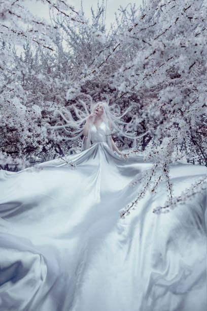 istock Beautiful woman in white cherry blossom 1354569676