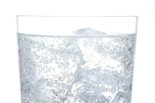Macro shot of glass with soda drink and ice cubes. Detail of soda drink with ice cubes, fresh beverages background. soda with ice stock pictures, royalty-free photos & images
