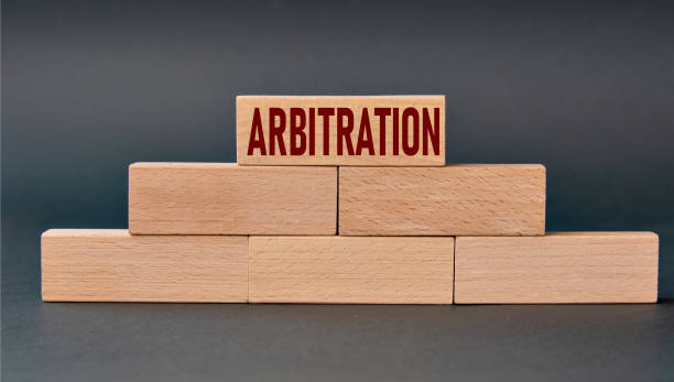 istock ARBITRATION - word on wooden blocks on dark background 1354574177