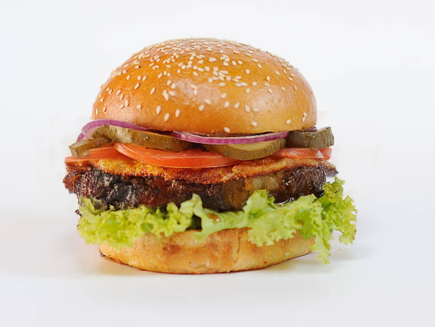 istock appetizing burger with a large fatty chop and vegetables 1354577818