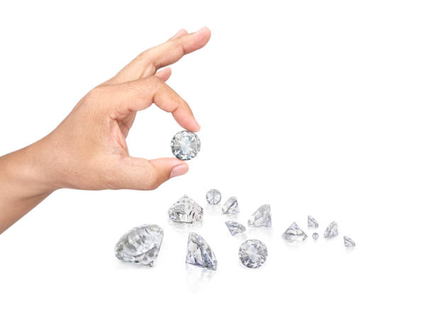 istock Hand holding diamond isolated on white background 1354578444
