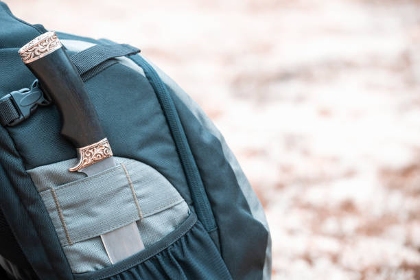 istock Matching knife in backpack pocket in the forest. Hiking equipment. 1354580556