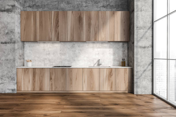 istock Concrete wall with minimalist wood kitchen cabinet 1354582831