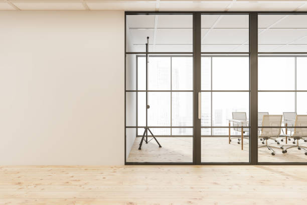istock Empty beige wall and meeting room glass door 1354584121