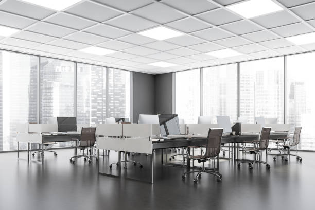 istock Business room interior with armchairs and computers in row, city view 1354584222
