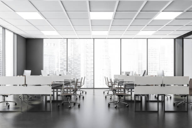 istock Business room interior with armchairs and computers in row, city view 1354584328