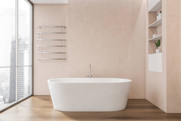istock Pink bathroom with white bathtub on dark wood floor 1354585733