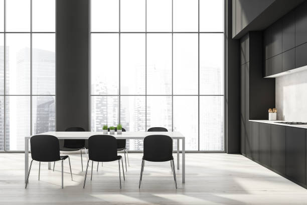 istock Black kitchen interior with eating table and kitchen set near window 1354586635