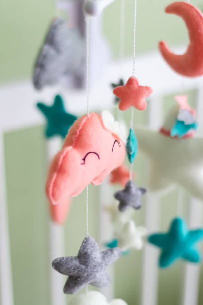 istock Textile soft toys rotate over the baby's crib. mobile for the cradle. 1354587680