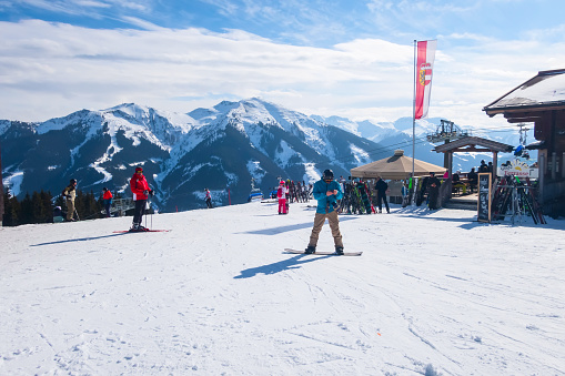 Saalbach, Austria - March 1, 2020: People skiing at ski slope of austrain winter resort