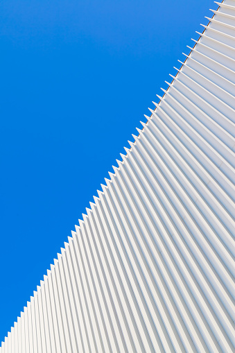 Abstract architectural background with wall and blue sky