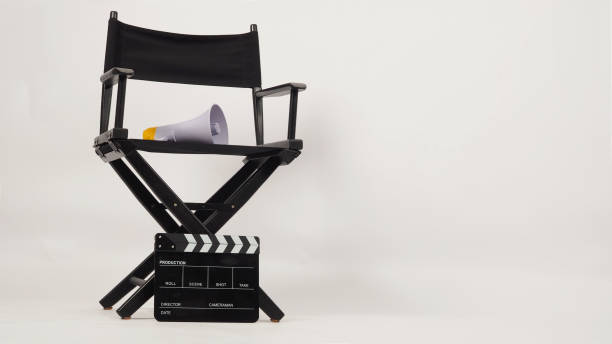 istock Black director chair and Clapper board with yellow megaphone on white background 1354589304