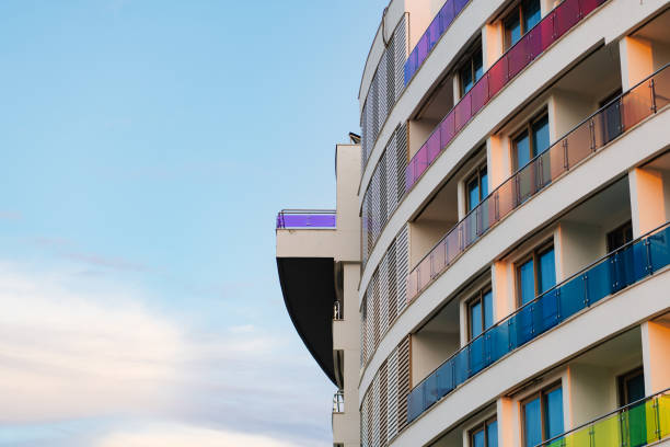 istock the wall of a multi-storey building with multi-colored glass balconies 1354589352