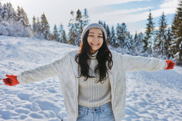 istock Woman in Winter Clothes Raised Hands Outdoors in Forest 1354589452