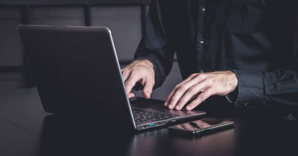 istock Businessman using a smartphone and notebook in a moddy office 1354590945