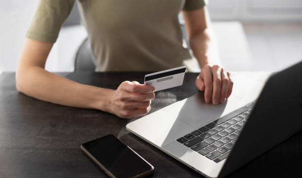 istock Online payment. Woman using laptop and credit card 1354591155