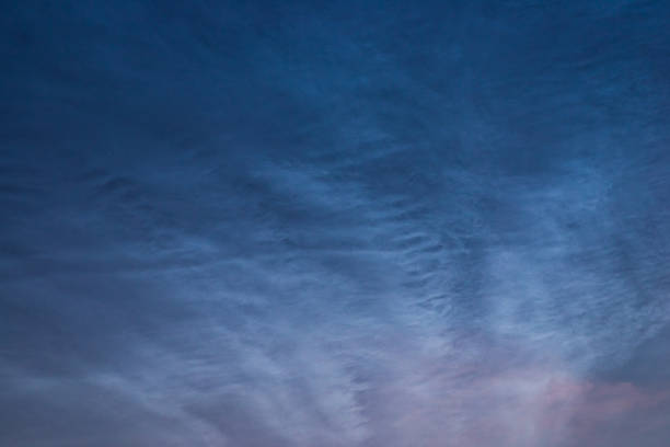 istock Noctilucent clouds close up on a summer night. Glowing clouds in the night sky. 1354606423