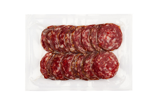 top view of smoked salami sausages slices in transparent vacuum plastic packaging isolated on white background