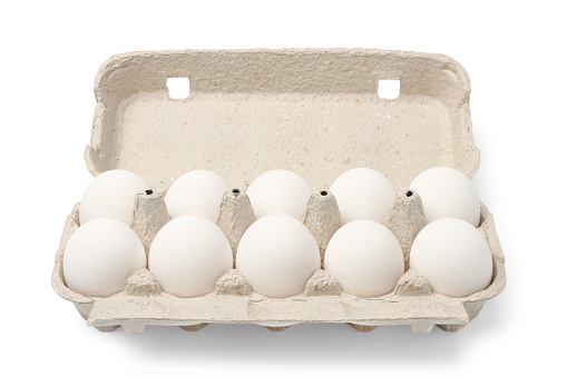 Ten chicken eggs in cardboard cassette isolated on white