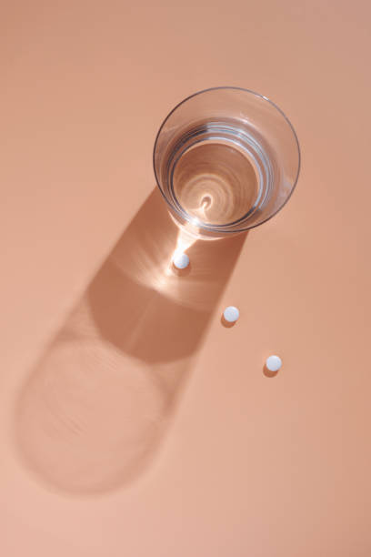 istock Glass of water and pills 1354608582