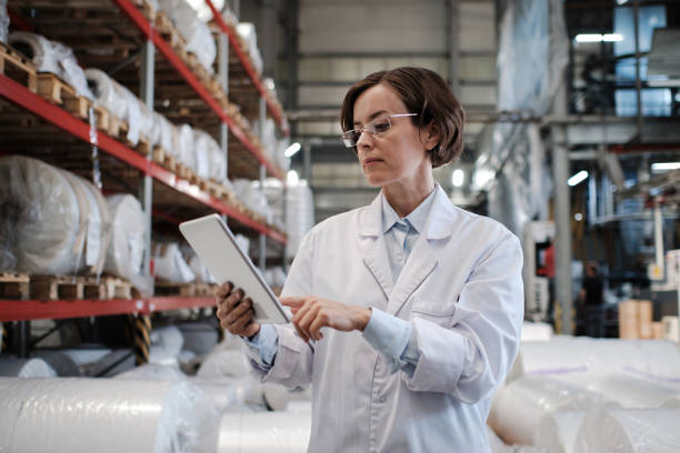 Female worker using tablet at the factory