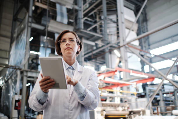 istock Female worker using tablet at the factory 1354610776