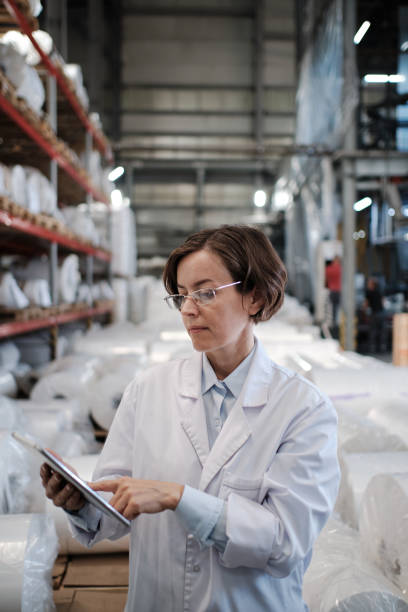 istock Female worker using tablet at the factory 1354610778