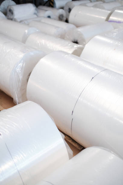 istock Plastic rolls stored in rows at factory warehouse 1354610895
