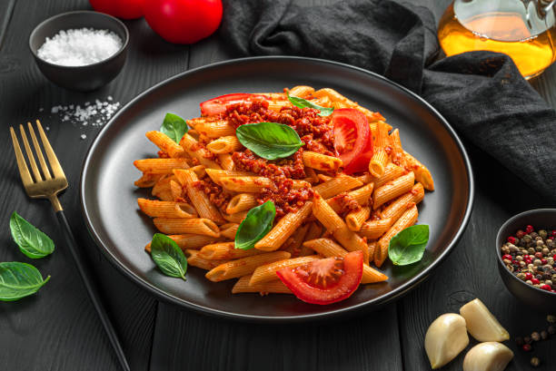 istock Bolognese pasta with basil and fresh tomatoes close-up 1354612025