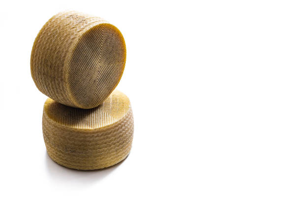 Queso Manchego cheese two cheese wheel isolated on white background, studio shot cut out