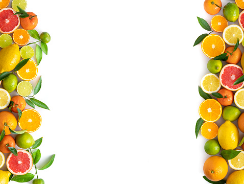 Citrus fruits cut arrangement oranges tangerines lime lemon and grapefruit with leaves isolated on white background leaving copy space