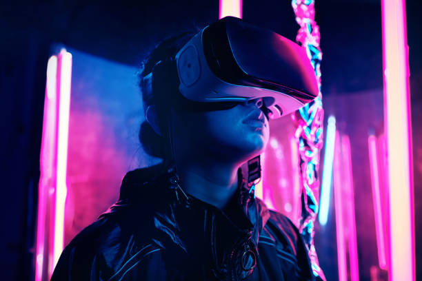 Neon lgiht portrait of girl in VR glasses Portrait of young girl wearing Virtual Reality goggles. She is surrounded with neon light. Virtual Reality Point of View concept virtual reality simulator photos stock pictures, royalty-free photos & images
