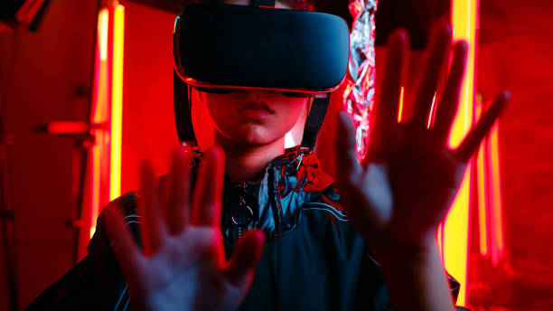 Teenager in virtual reality goggles gesturing on virtual screen