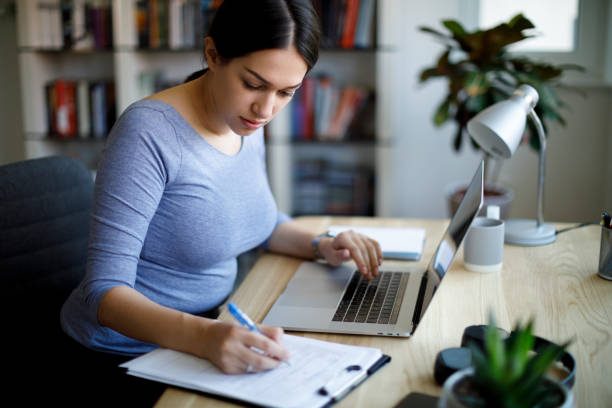 istock Serious young woman working at home 1354626338